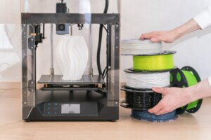 Printing original products on a 3D printer. Designer white vase, printed on a 3D-printer.